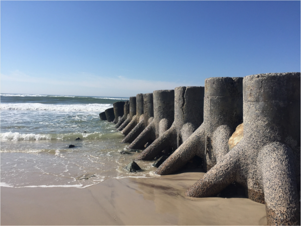 Concrete shoreline protection structures extending into the Atlantic Ocean at Ocean Beach on Fire Island, New York.