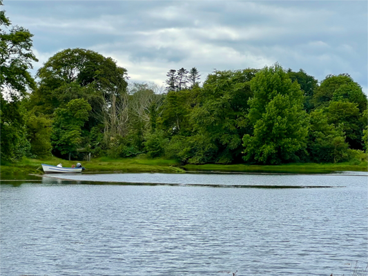 Scenic countryside landscape near Kenmare, Ireland, with rolling green hills and the rugged natural beauty of County Kerry.